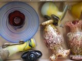 many different vases in a box on the shelf