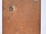 a piece of wood with holes in it on a white surface