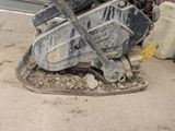 a machine that is sitting on the ground in front of a building