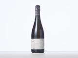 a bottle of wine sitting on top of a white table