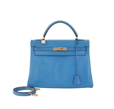 a blue leather handbag with gold hardware