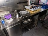 a kitchen with stainless steel counter tops and a sink