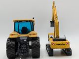 two toy tractors that are sitting next to each other