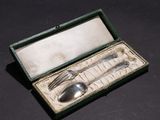 a silver spoon and fork in a box on a table