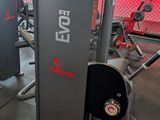two machines that are sitting in a gym room