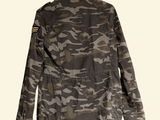 the jacket is made of camouflage fabric and has a buttoned closure