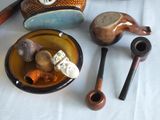many different types of pipes and bowls on the table