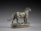 bronze statue of a lion on a pedestal on a gray background