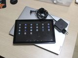 a tablet computer sitting on top of a desk next to a laptop computer