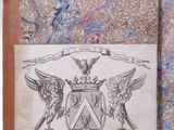 an old book with a picture of a coat of arms on it