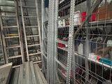 many metal shelves in a room with many different types of items