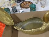 a gold duck in a box with other items in the background