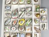 a white box filled with assorted porcelain objects