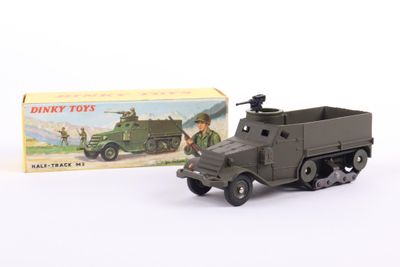 toy army truck and box on a white surface with a box in the background