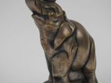 a statue of an elephant that is sitting on top of a table