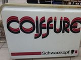 a sign that says coffure on the side of a building