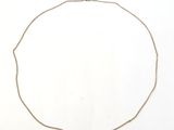 a close up of a necklace on a white surface with a white background