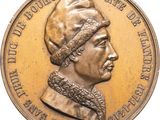 une image représentant une médaille d'or sur laquelle figure le portrait d'un homme portant un turban