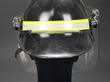 a close up of a fireman ' s helmet on a black stand