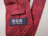 a close up of a red neck tie with a label on it