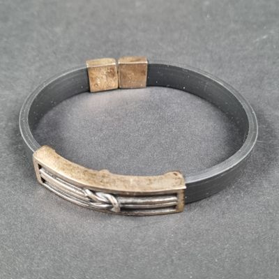 bracelet en argent et en or avec des fermoirs carrés sur un fond gris