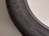 a close up of a tire on a wall with a white background