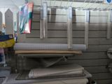 many rolls of paper on a rack in a store