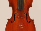 an old violin with a bow hanging from it ' s back
