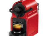 a red neso machine with a cup of coffee