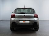 the rear of a silver citrole parked in a white room