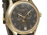 the watch is gold and black with a black dial