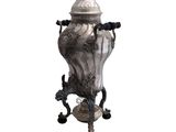 a silver vase on a stand on a white background