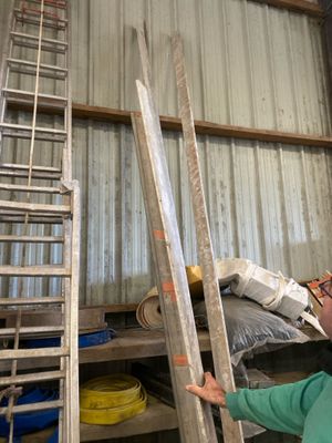 a man that is standing next to some ladders