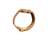 a gold ring with black stones on it on a white background