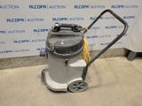 a silver and black vacuum cleaner sitting on top of a carpet