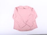 pink shirt on a white background next to a laptop computer