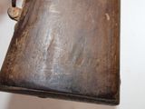 an old book hanging from a hook on the wall