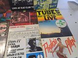 several different records are on a table in a room