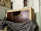 a pile of boxes and a cabinet in the corner of a room