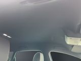 someone is sitting in the passenger seat of a car with their cell phone in their hand