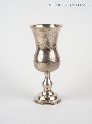 a silver cup that is sitting on a table