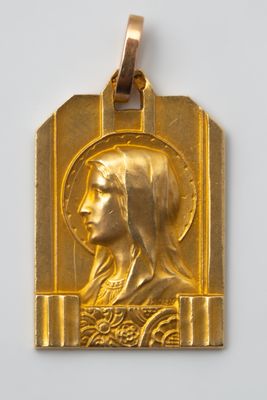 a close up of a gold medal with a woman ' s face on it