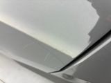 a close up of a car ' s front bumper with scratches on it