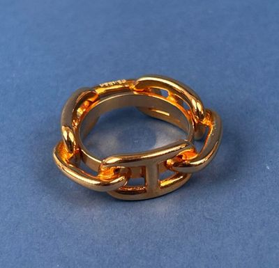a close up of a gold ring on a blue surface