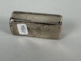 an old silver cigarette case sitting on top of a white table