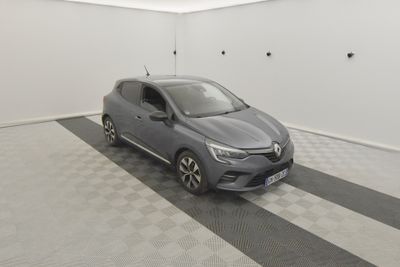 the grey car is parked in the garage on the checkered floor