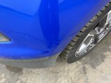 a close up of a blue car ' s front bumper