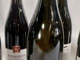 several bottles of wine are lined up on a table