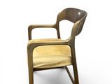 an image of a wooden chair with a yellow seat and back
