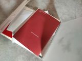 someone opened a red book in a white box on the floor